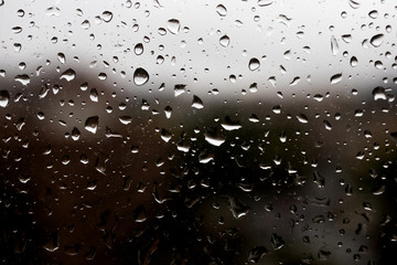 Rain water drops on a window. Moody and sad mood.