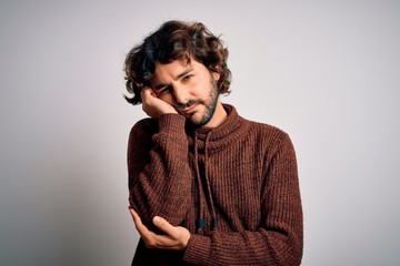 Young handsome man with beard wearing casual sweater standing over white background thinking looking tired and bored with depression problems with crossed arms.