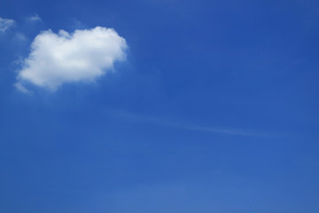White fluffy cumulus cloud in the sunny blue sky