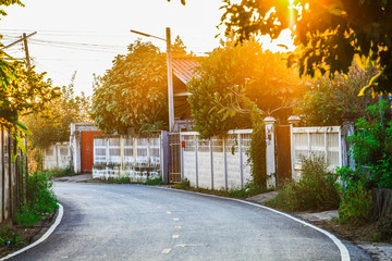 Naklejka premium Serene road on small village, Thailand. Natural sunlight lighting the road.