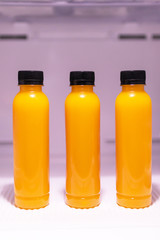 Bottle of orange juice in refrigerator get ready for summer.