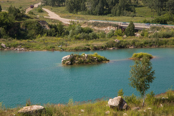 Flooded open pit quarry with blue water lake