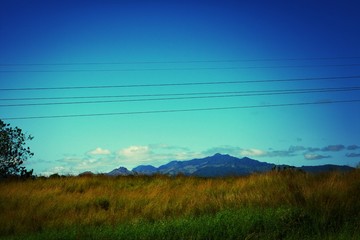 Fototapeta na wymiar View Of Countryside Landscape Against Blue Sky