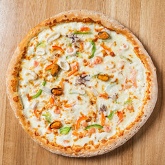 tasty italian pizza on the wooden background