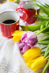 Beautiful morning, two cups of coffee and a bouquet of bright and beautiful tulips.