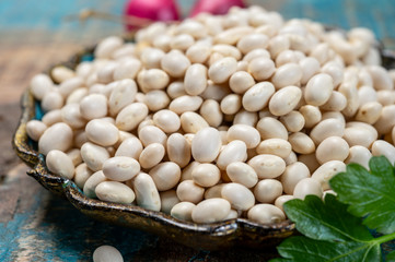 White dried small beans legumes in bowl