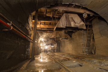 Fototapeta na wymiar Scoop ramp scraper slide in gold mine underground tunnel