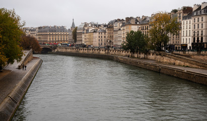 Fototapeta na wymiar Paris. Seine River Embankment in Autumn Day