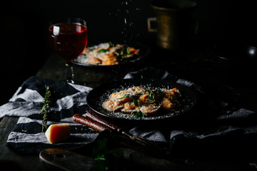 Ravioli with pumpkin and cheese on a dark background