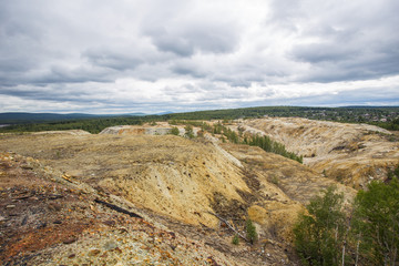 Fototapeta na wymiar Dull landscape on abandoned mining site with surface dump