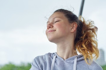 Portrait of teenage girl 15 years old, dreaming girl with closed eyes, smiling pretty female in...