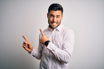 Young handsome man wearing elegant shirt standing over isolated white background Pointing aside worried and nervous with both hands, concerned and surprised expression