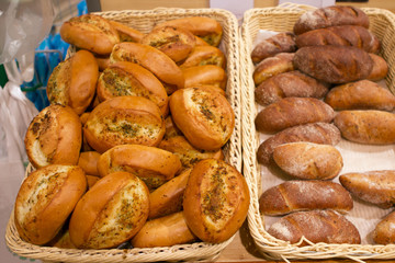 fresh buns with garlic, cheese, seasonings, dill, herbs on a bakery counter
