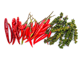 Top view of herbs and spices with top frame of red hot chilli pepper and dried chili and fresh green peppers isolated on white background.