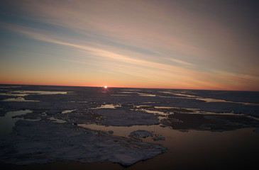 last rays of the sun over the frozen sea
