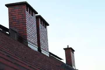 Brown Chimneys on roof - obrazy, fototapety, plakaty