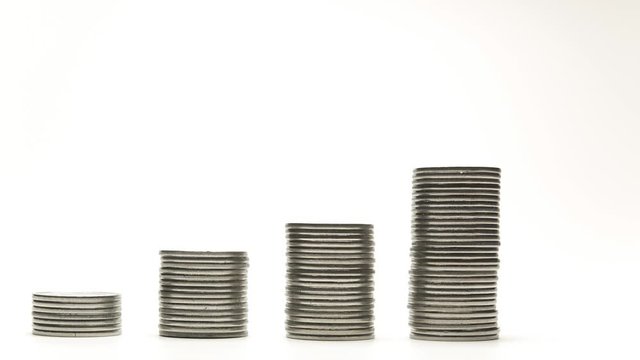 Silver coins on stacks are decrease and increase on white background stop motion animation