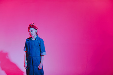 Young stylish girl in the Studio on a colored neon background. Music dj poster design. Portrait of a young girl dancer.