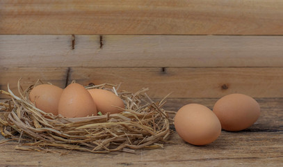Chicken eggs that are laid on a wooden floor