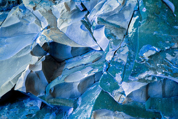Turquoise and blue natural stone texture. Sedimentary rock is unique for every natural compound - all kinds of faults, cracks, faults, folds. Different colors and unique pattern.  