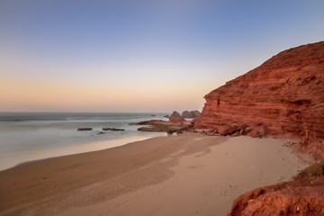 Fototapeta na wymiar Landscape of Legzira Beach with its natural arches at the coast of Atlantic ocean. Legzira Beach is located on the ocean coast of Morocco, in Sidi Ifni, close to Agadir.