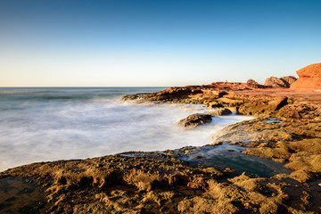 Landscape of Legzira Beach with its natural arches at the coast of Atlantic ocean. Legzira Beach is located on the ocean coast of Morocco, in Sidi Ifni, close to Agadir.