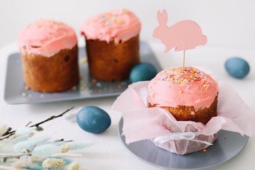 Easter table with Easter cakes, painted eggs and tree branches. Kulich decorated with icing.  Happy Easter concept