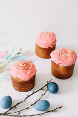 Easter table with Easter cakes, painted eggs and tree branches. Kulich decorated with icing.  Happy Easter concept