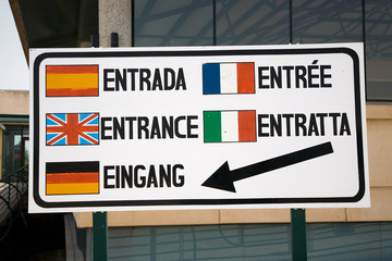 Multi-language sign in Europe saying "Entrance" in Spanish, English, Italian, German and French