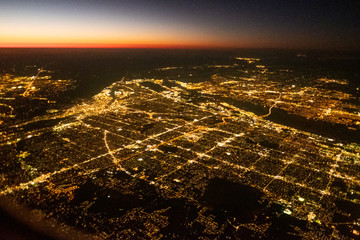 City lit up at night dusk, from overhead