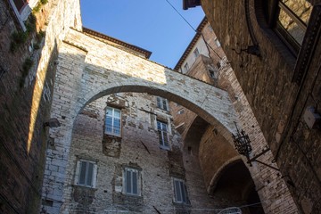 Fototapeta na wymiar ancient historic arch between houses in the medieval part of Perugia city, Italy