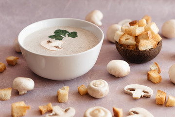 creamy mushroom cream soup with champignons serving in delicate pink colors