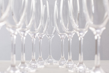 Glasses for champagne on a gray background, glass dishes for drinks