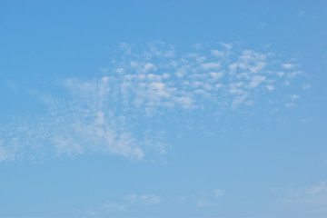 blue sky background with tiny clouds. Evening sky clouds.