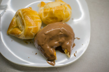 the process of making rolls of puff pastry coated with melted chocolate at home