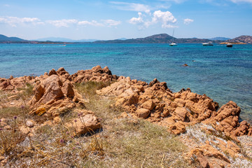 Picturesque Tyrrhenian Sea harbors with yachts offshore Isola Tavolara island off northern coast of Sardinia, Italy
