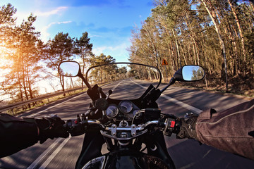 riding a motorcycle on the road on a sunny day
