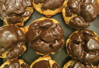 Top View of a Tray of French Choux Pastries with Chocolate Ganache 