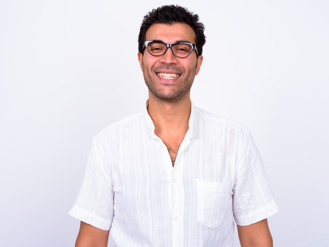 Portrait of happy handsome Turkish man with eyeglasses smiling