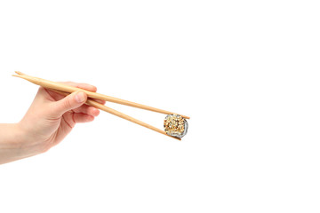 Female hand with chopsticks holds sushi roll, isolated on white background