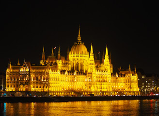Fototapeta na wymiar View of the Hungarian Parliament Building and the Danube river at night in Budapest, Hungary.