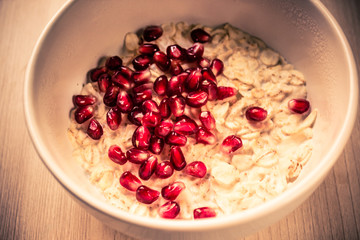 Oatmeal with pomegranate berries, a plate with breakfast