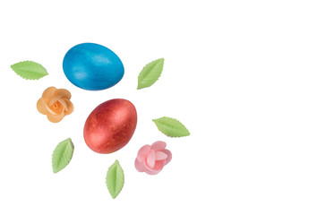Easter eggs and flowers with leaves from a sweet decor isolated on a white background.