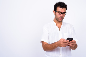 Portrait of handsome Turkish man with eyeglasses using phone