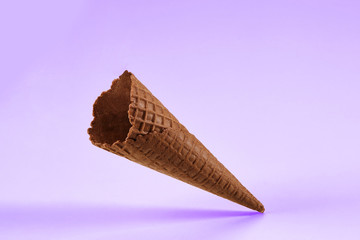 Empty, crunchy, chocolate wafer cone for ice cream isolated on white. Concept of food, treats....