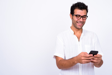 Portrait of happy handsome Turkish man using phone