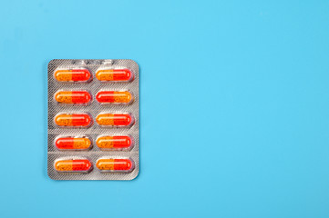 Pharmaceuticals Pills on a blue background. Empty space for text.