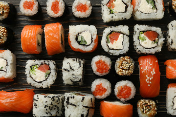 Flat lay with sushi rolls on wooden background. Japanese food