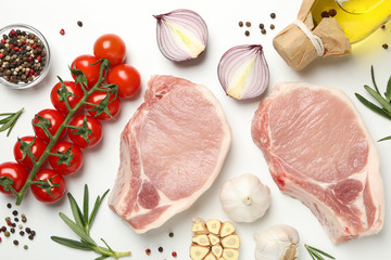 Composition with raw meat and ingredients on white background, top view