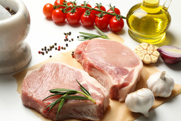 Composition with raw meat for steak and ingredients on white background